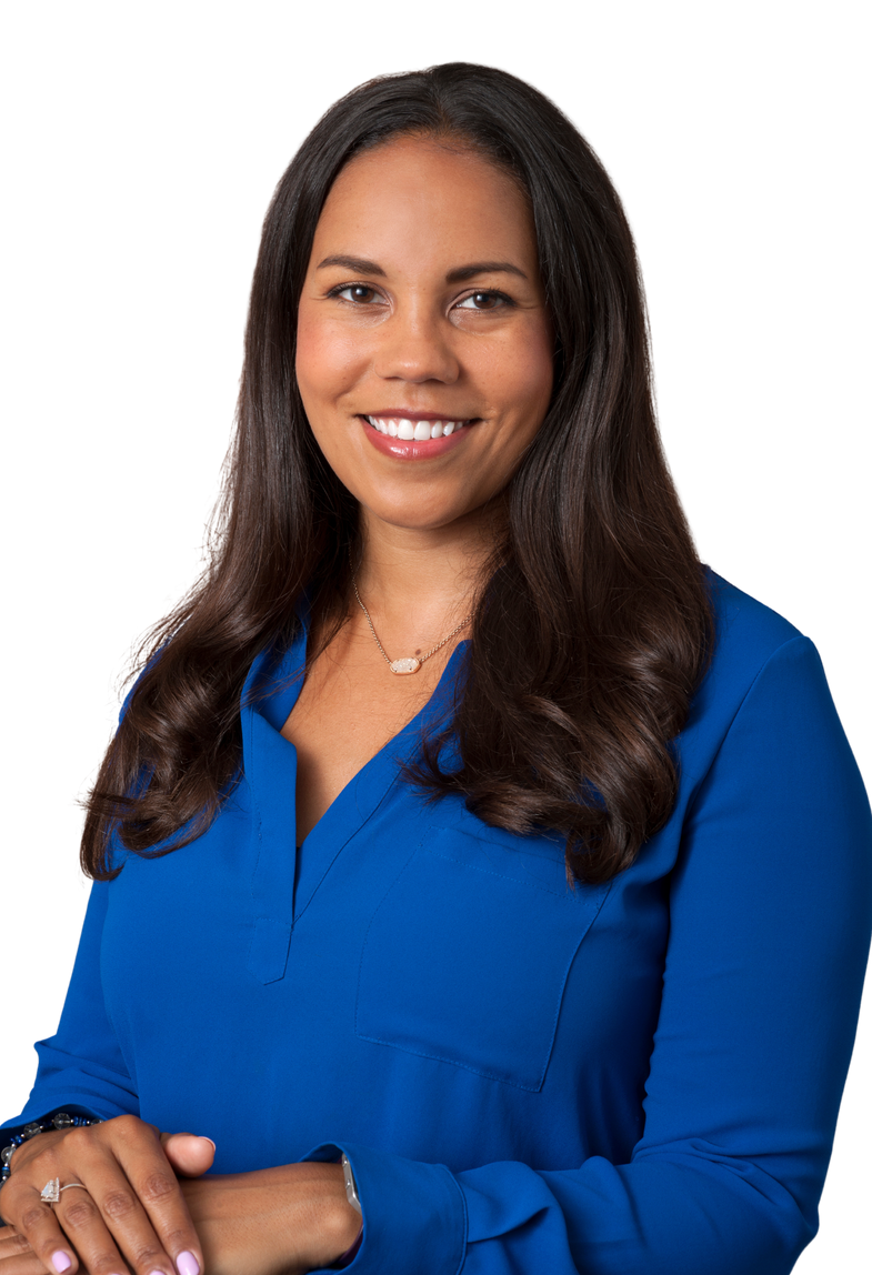 A light brown woman smiling in a blue shirt with dark brown hair.